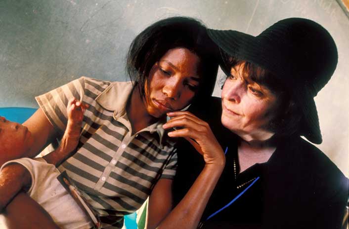 Dr. Lynne Nasrallah comforts a distressed Haitian mother holding her baby boy with a severe skin disease.