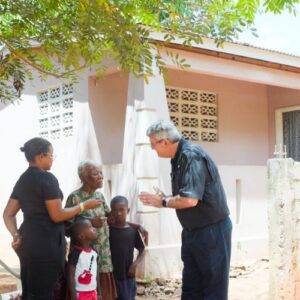 FFTP President/CEO Ed Raine with a family outside their new home thanks to FFTP Haiti project
