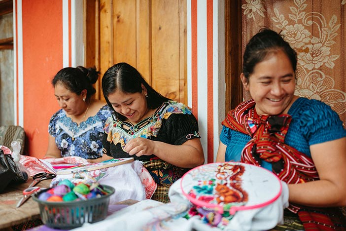 A group of women engaged in the art of embroidery.